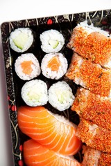 Close-up of sushi food on tray against white background