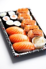 Sushi food on tray against white background