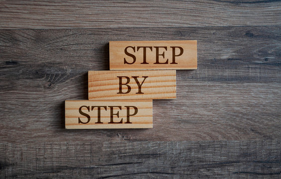 Cubes and dice with step by step on wooden background