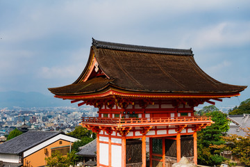 Main Gate of Kiyomizu-dera Temple with brown roof and red wooden base in Kyoto, Japan