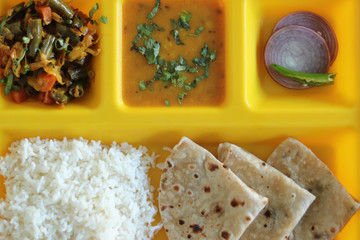 Simple Indian Vegetarian Combo with Wheat Roti Lentil Veg Curry Rice and Onion