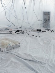 Cables Covered In Dust Sheets With Paint Roller In Foreground