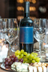 Bottle of Red Wine Cheese Assortment for Snack. Free space for text.