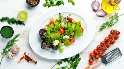 Salad of vegetables, blood sausage and mushrooms on a plate. Top view. free space for your text....