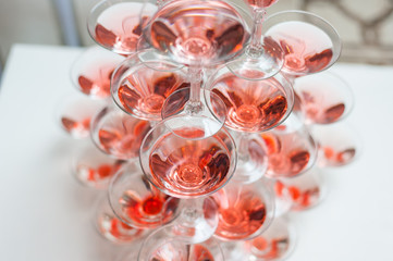 Luxury Banquet table with a pyramid of champagne glasses with cherries.