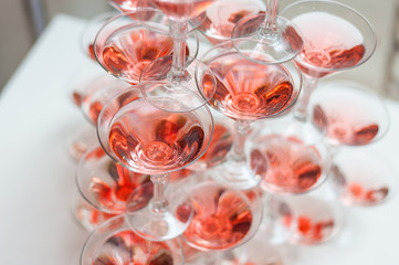 Luxury Banquet table with a pyramid of champagne glasses with cherries.