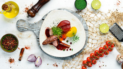 Baked duck fillet with pear and cranberry sauce. Top view. free space for your text. Rustic style.