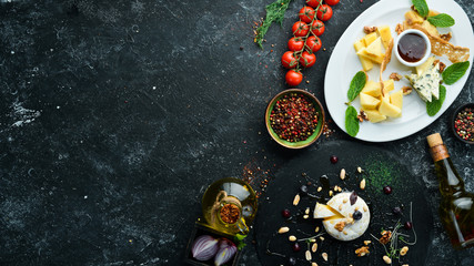 Cheese dishes, cheese slicing on a black stone background. Top view. free space for your text. Rustic style.