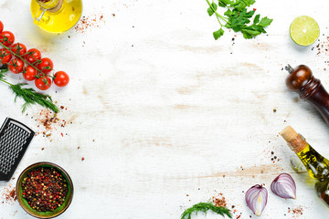 Food banner. Spices, vegetables and herbs on a white wooden background. Top view. free space for...