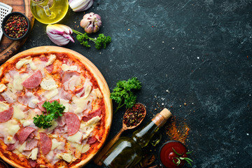 Homemade pizza with bacon, chicken and salami sausage. Top view. free space for your text. Rustic...