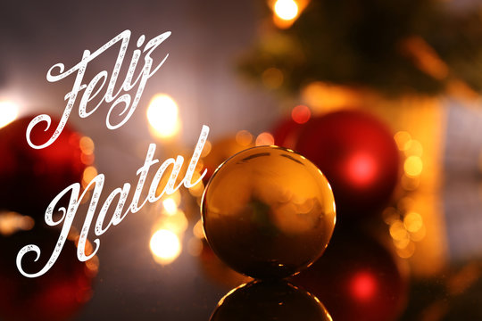 Christmas greetings with portuguese text Feliz Natal (merry christmas) and Christmas baubles