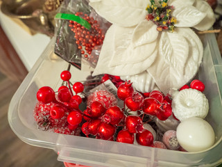 Christmas composition of red berries, white poinsettia flower, balls in plastic box. Christmas and New year background.