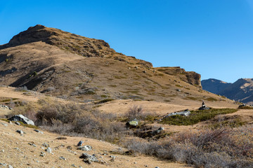 Rocks and dry grass in North Caucasus mountains in autumn on sunny day