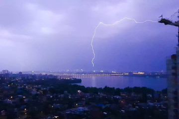 Naklejka na ściany i meble Lightning during thunderstorm in the sky. Natural phenomenon of