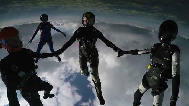 Skydivers prepare to jump from airplane. Open door. Extreme sport. Sunny day. Professionals