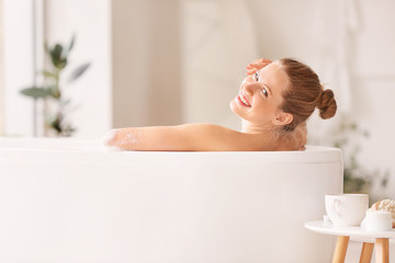 Obraz premium Beautiful young woman taking bath at home