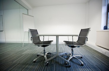Side view of small table and two chairs in office