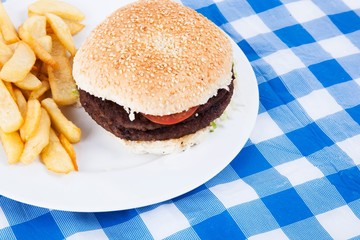 Close-up of hamburger and French fries on table