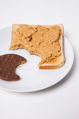 Slice of bread and chocolate biscuit on plate