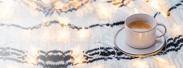 Cosy hygge banner with coffee and lights.