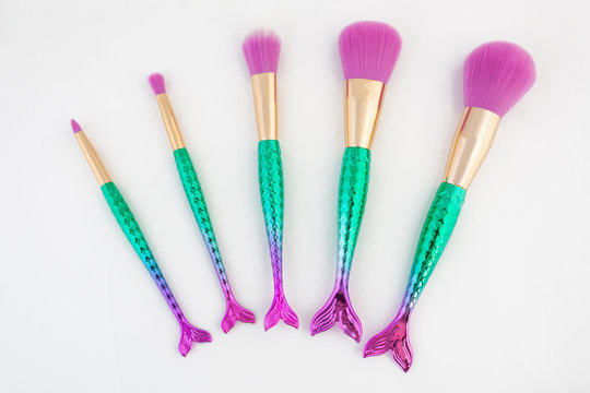 Make up brushes in mermaid theme cosmatic makeup brushes on a white background.