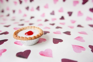 Close-up of cupcake over heart shaped background