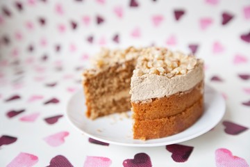 Close-up of cake with missing piece over heart shaped background