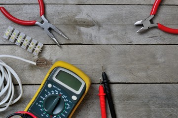 electro tool and tester on a wooden background. copy space