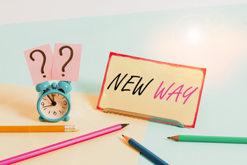 Handwriting text New Way. Conceptual photo To move from one place To make changes and do something in a new way Mini size alarm clock beside stationary placed tilted on pastel backdrop