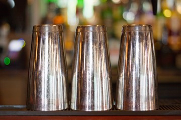 Close-up view of three steel glass kept upside down