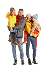 Fototapeta premium Happy family in winter clothes on white background