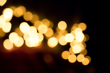 Abstract background of glowing yellow lights in the dark. Bokeh effect.