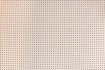Light beige perforated leather texture close up