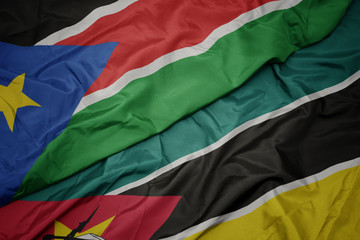waving colorful flag of mozambique and national flag of south sudan.