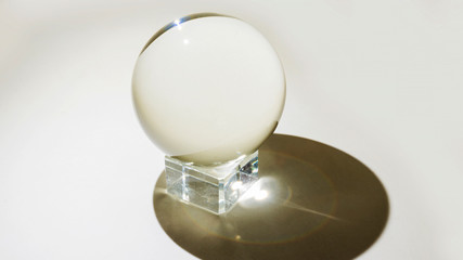 Fototapeta na wymiar Religious round glass balls placed on a crystal platform isolated on white background. Magic ball.
