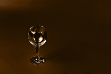 Wine glass on chocolate tones background