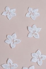 Texture lace fabric. lace on white background studio. thin fabric made of yarn or thread. a background image of ivory-colored lace cloth. White lace on beige background.