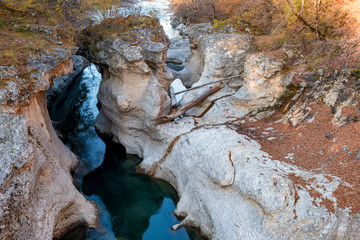 Fall landscape with quick narrow mountain river with clean water