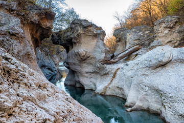 Fall landscape with quick narrow mountain river with clean water