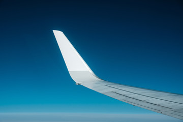 blank airplane wing blue sky aerial background