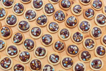 Mendiants with chocolate and biscuits with nuts and dried fruits. French chocolate candy for Christmas holiday from above.