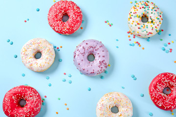 Sweet tasty donuts on color background