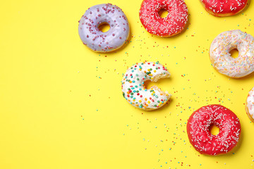 Sweet tasty donuts on color background