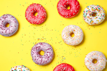 Sweet tasty donuts on color background