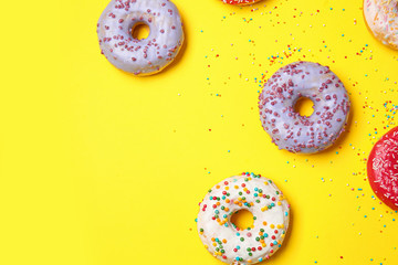 Sweet tasty donuts on color background