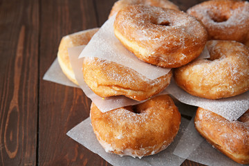 Sweet tasty donuts on wooden background