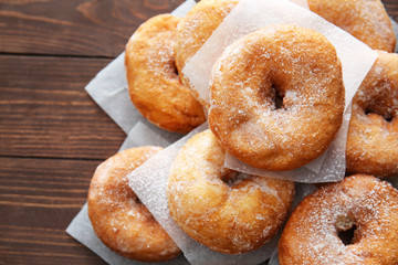 Sweet tasty donuts on wooden background