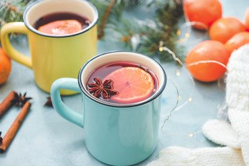 Mugs of tasty mulled wine on table