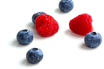blueberries and raspberries isolated on white