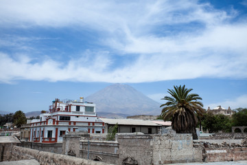 El Misti Volcano in Arequipa, Peru, sunny weather, clouds, city ​​in the foreground. 